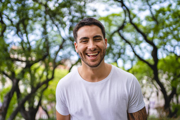 Cheerful hispanic man looking at the camera Portrait of a handsome man laughing and toothy smiling at the camera 25 year old man portrait stock pictures, royalty-free photos & images