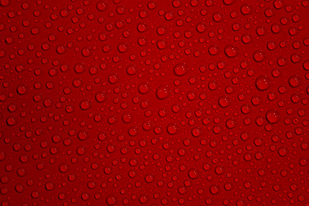 istock Homogeneous wet with water drops dark red background with even pattern, closeup, details 1195947953
