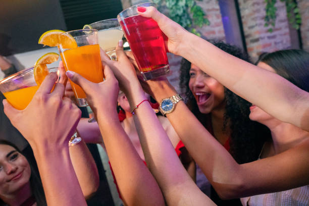 istock Girlfriends celebrating drinking cocktails inside the disco 1195959386
