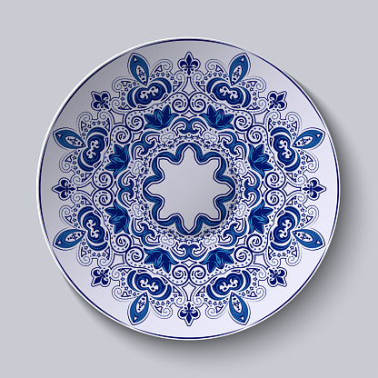 Blue decorative ornament. Pattern is applied on a ceramic plate. Vector illustration.