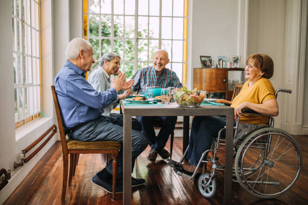 enjoying healthy food and good company - senior adult nursing home eating home interior imagens e fotografias de stock