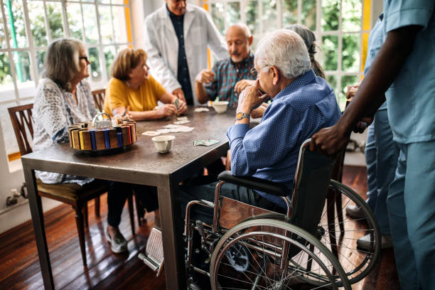 istock Seniors having fun playing cards in nursing home 1195965498