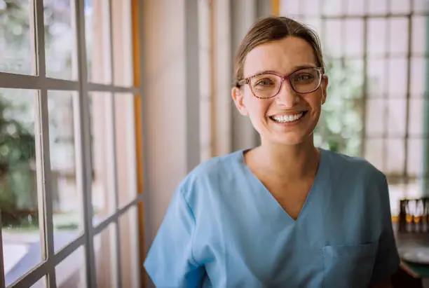 Smiling Argentinian female nurse in medical scrubs