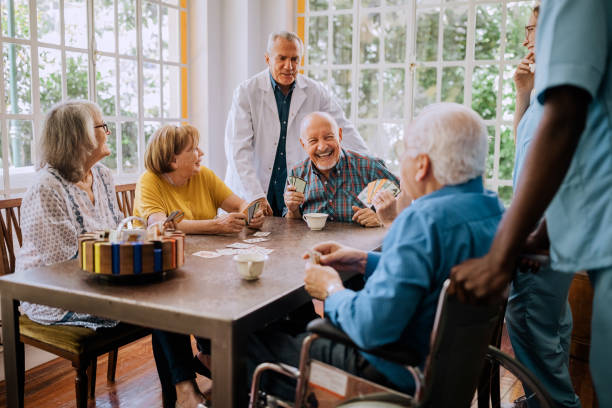 istock Seniors having fun playing cards in nursing home 1195965574