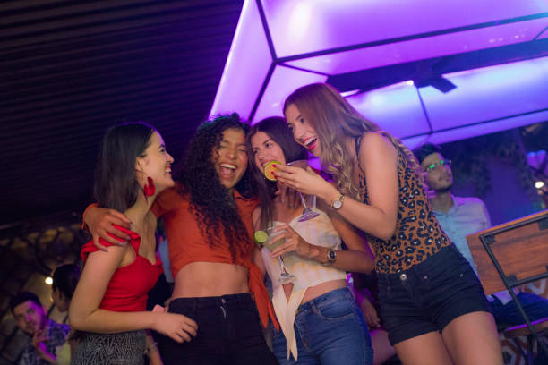 istock Girlfriends celebrating drinking cocktails inside the disco 1195967096