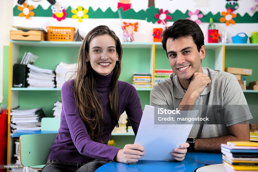Teacher and parent meeting in school classroom  Teacher Stock Photo