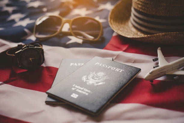 istock Passport is placed on the US flag. Preparing for a legitimate journey 1195971215