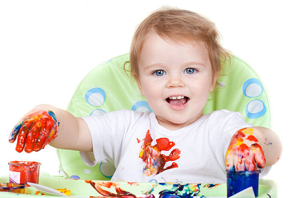 istock cute girl creates picture sitting at table with painted hands 119598573