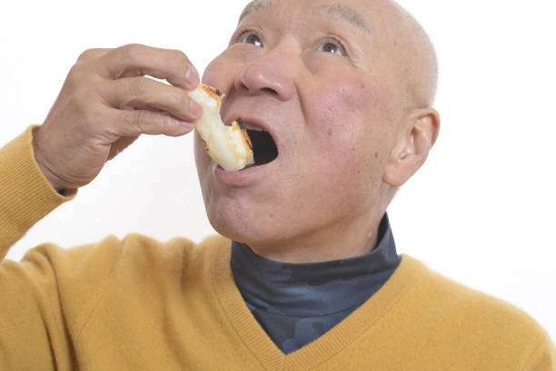 istock Senior eating mochi 1195986628