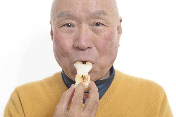 istock Senior eating mochi 1195986639
