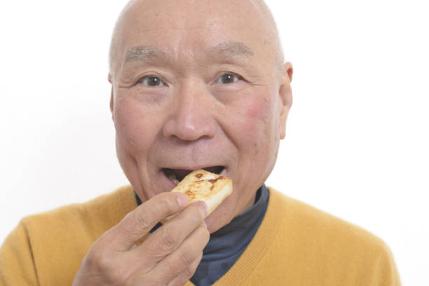 istock Senior eating mochi 1195986640