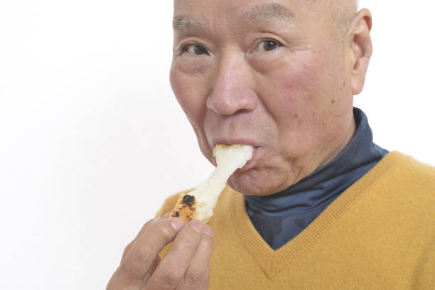 istock Senior eating mochi 1195986647