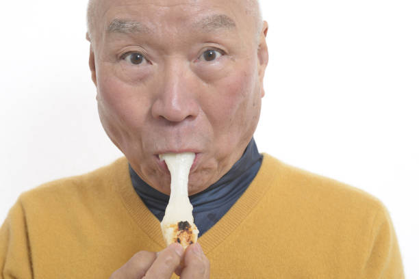 istock Senior eating mochi 1195986649