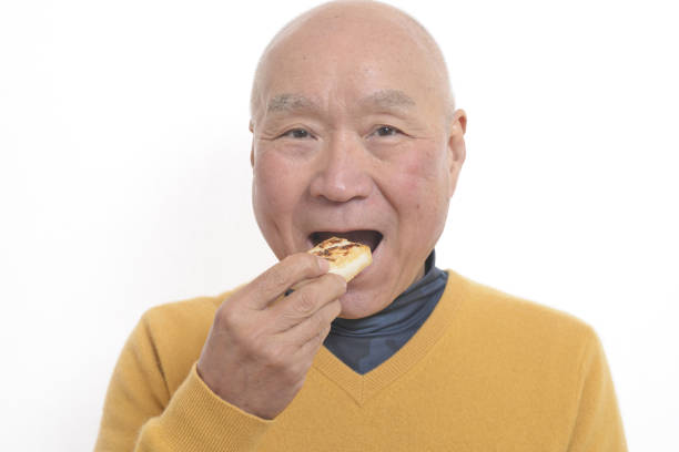 istock Senior eating mochi 1195986665