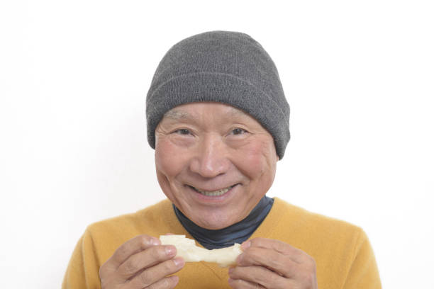 istock Senior eating mochi 1195986675