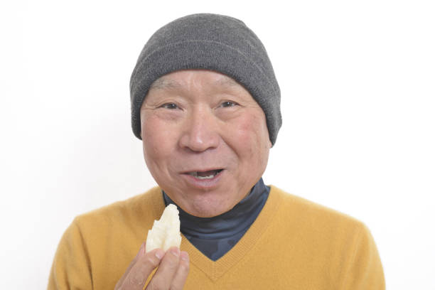 istock Senior eating mochi 1195986693