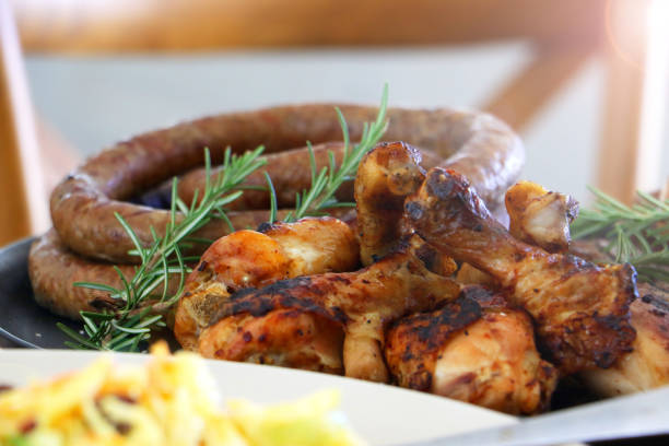 colourful barbeque braai plated meal consisting of chicken, steak, boerewors salad and coleslaw laid out and ready to eat on table