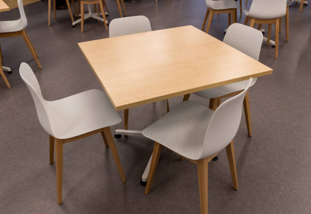 istock Wooden square table and white seats 1195994458