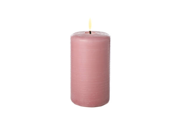 istock Pink burning candle isolated on white background 1195997064