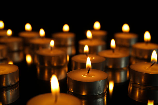 istock Group of burning candles on black background, close up 1195997768
