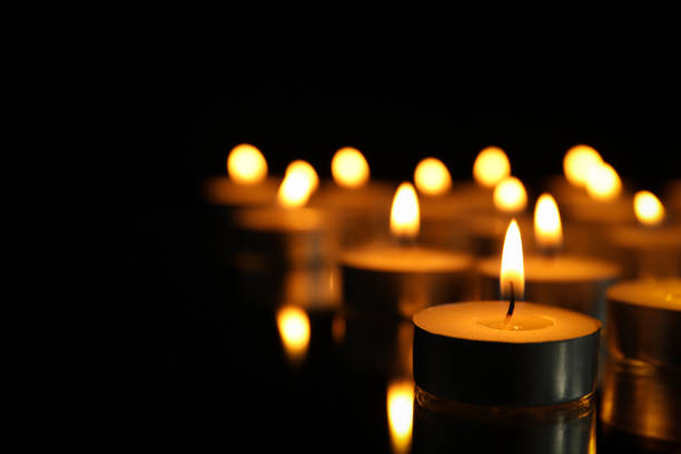 istock Group of burning candles on black background, close up 1195997778