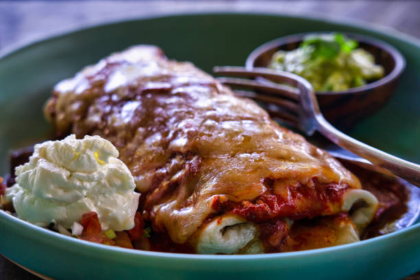 istock Vegetarian Enchilada with sour cream and guacamole side 1195997933