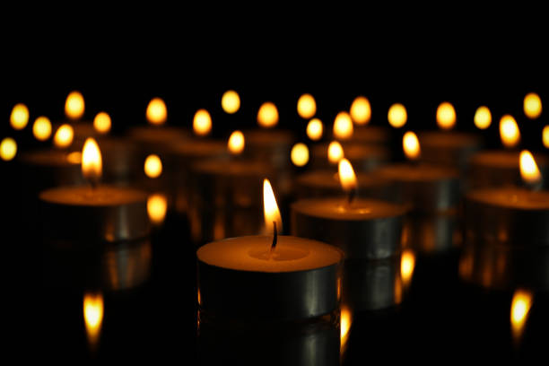 istock Group of burning candles on black background, close up 1195997943