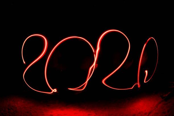 istock 2020 happy new year red light painting on black 1195999005