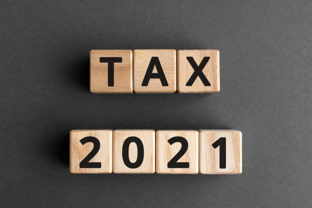 istock Tax 2021 - phrase from wooden blocks with letters 1196000646