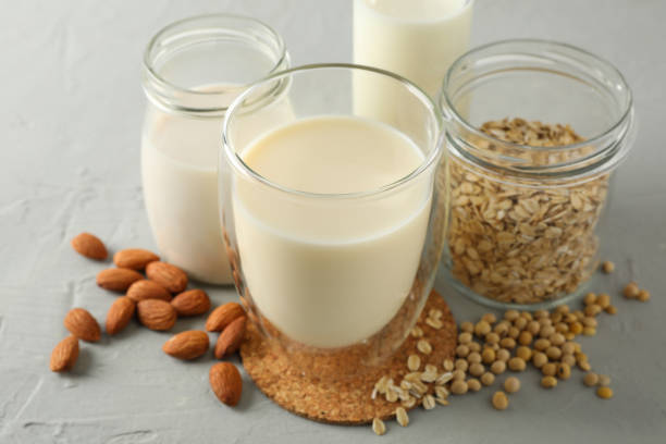 istock Bootle and glass of different types milk on gray background, space for text. Closeup 1196000768