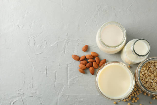 istock Bootle and glass of different types milk on gray background, space for text. Top view 1196000932