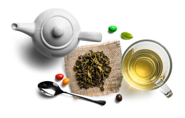 Green tea and accessories top view on white background