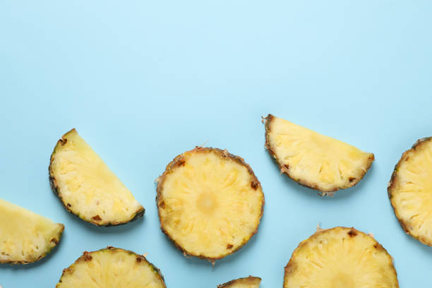 istock Flat lay with pineapple slices on blue background, space for text 1196002621