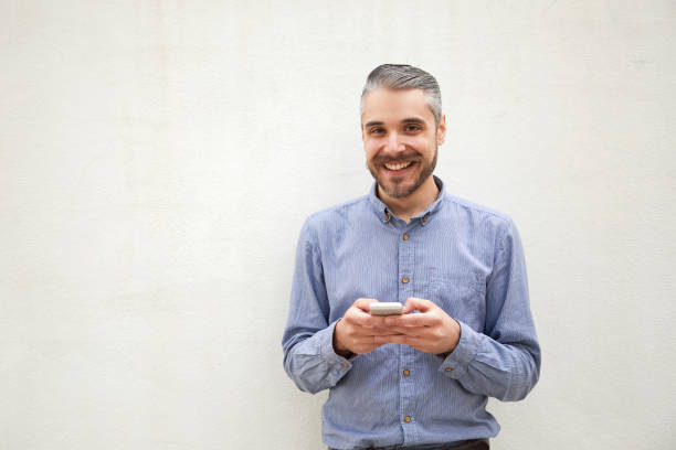 istock Cheerful positive man with mobile phone getting good news 1196004512