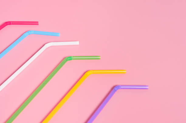 istock Rows of colorful straws for beverage on pink table. Space for text 1196005516