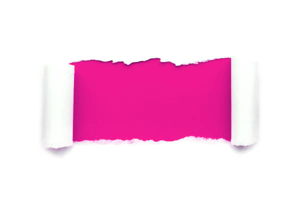 a hole in white paper with torn edges isolated on a white background with a bright pink color paper background inside. - note rose image saturated color imagens e fotografias de stock