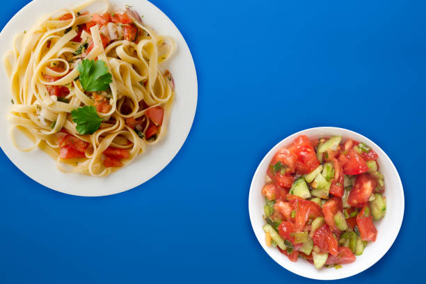 istock spaghetti on a white plate. spaghetti tomatoes, onions, cabbage on a colored background. healthy food 1196007459