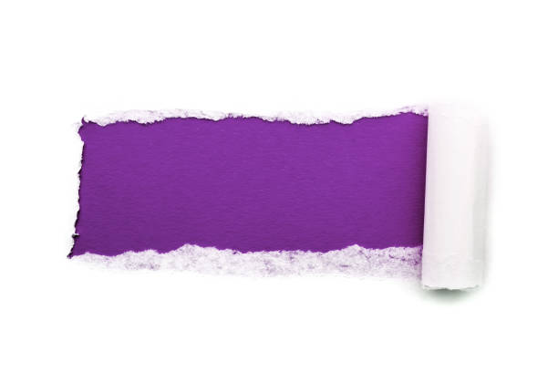 istock A hole in white paper with torn edges isolated on a white background with a bright violet color paper background inside. Good sharp paper texture. 1196007511