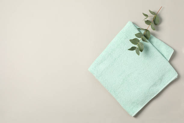 istock Towel and eucalyptus branch on grey background, space for text 1196007540