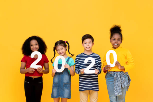 istock Cute mixed race kids smiling and holding 2020 numbers 1196007740