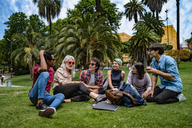 istock Professor lecturing to students in park 1196007780