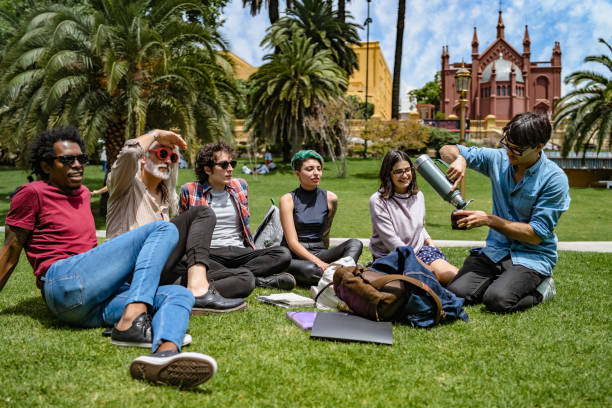 istock Professor lecturing to students in park 1196007801