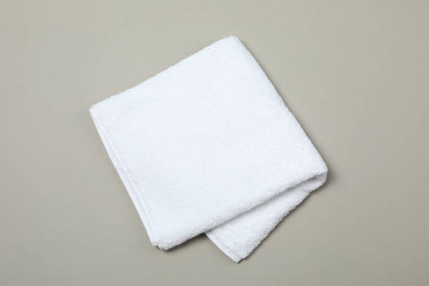 istock White towel isolated on grey background, top view and space for text 1196008531