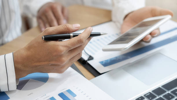 istock Business team brainstorming and discussing with financial data and report graph. Teamwork meeting working concept. 1196008791