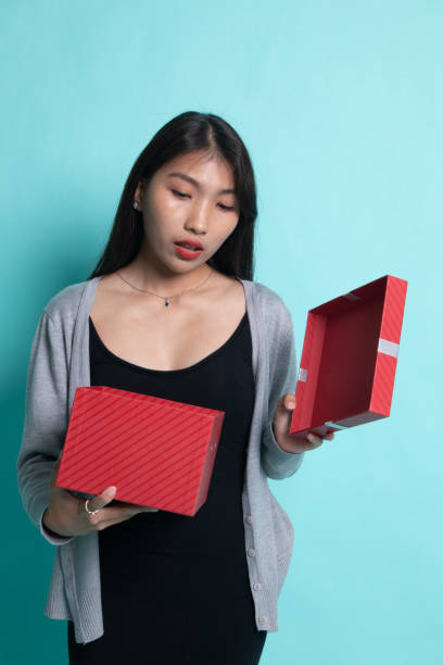 istock Young Asian woman open a gift box. 1196009516