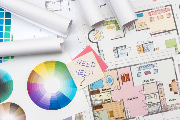 istock Colour palettes with house plan on desk top view. Designer working at new project 1196009863