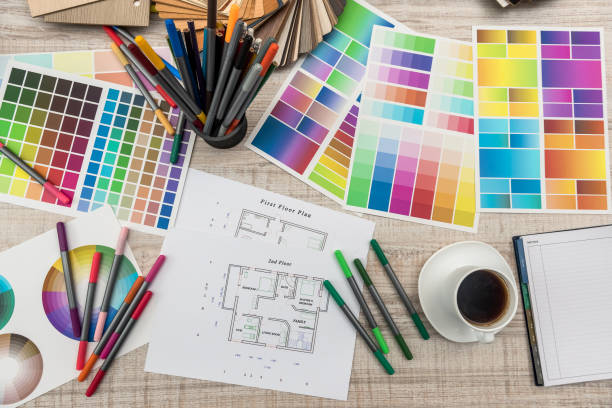 istock Colour palettes with house plan on desk top view. Designer working at new project 1196009907