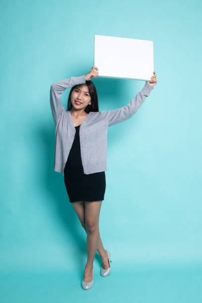 istock Young Asian woman with white blank sign. 1196009955