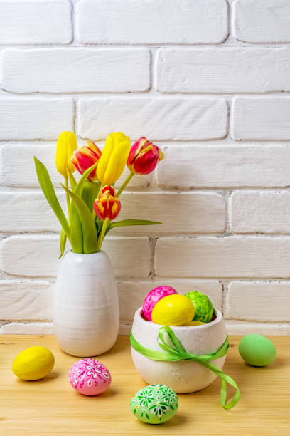 istock Pink, green, yellow hand decorated eggs Easter arrangement 1196010525