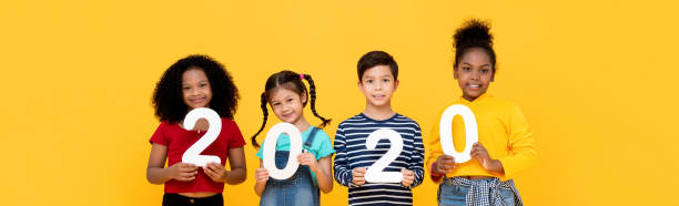 istock Kids smiling and holding 2020 numbers on banner background 1196010711